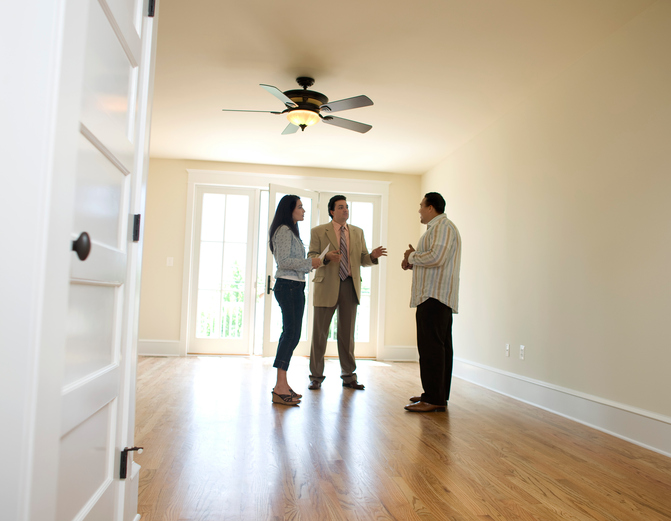 Couple with realtor looking at new home